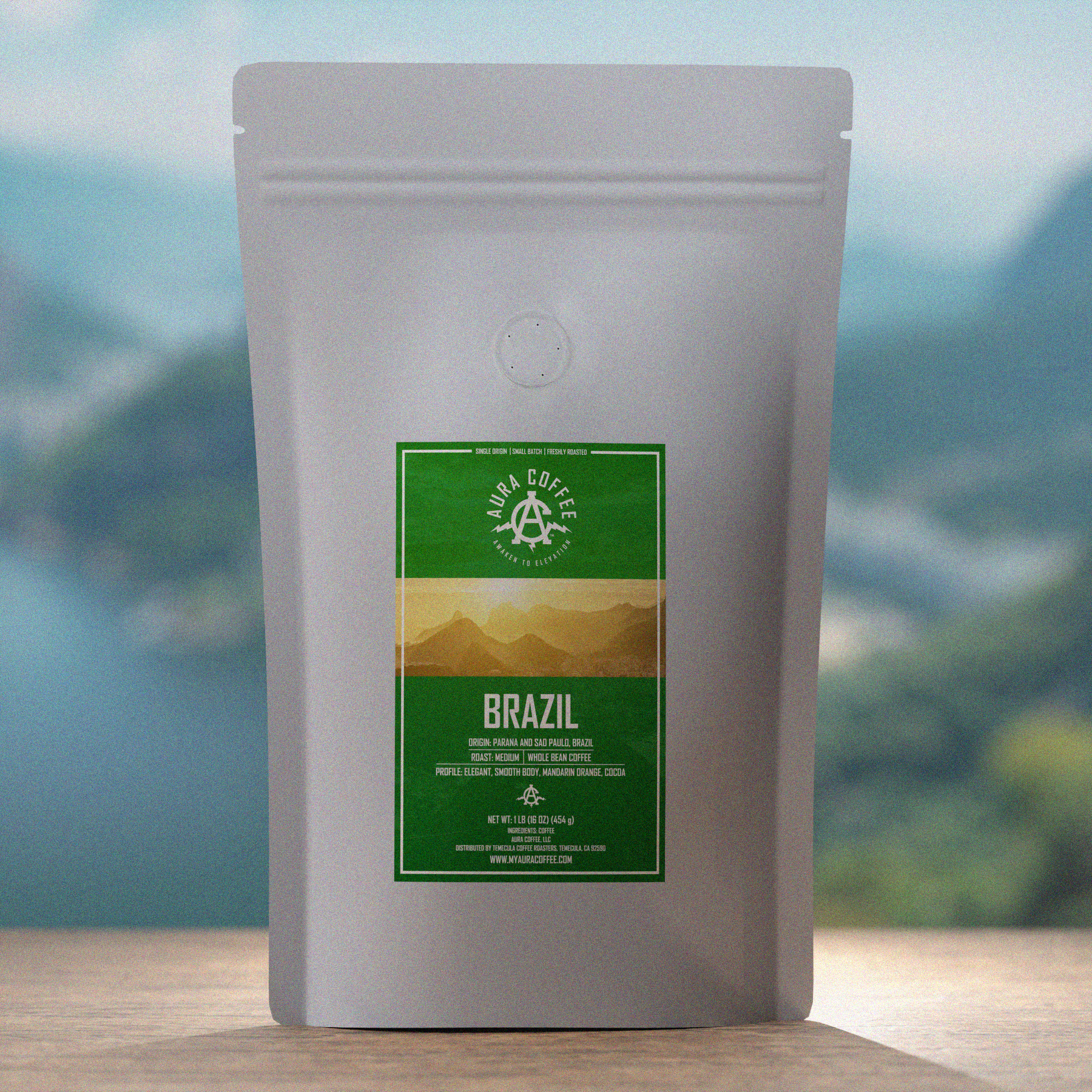 Aura Coffee Brazil Single Origin Coffee Pouch sitting on wooden table iconic Brazilian mountains and water in the background 