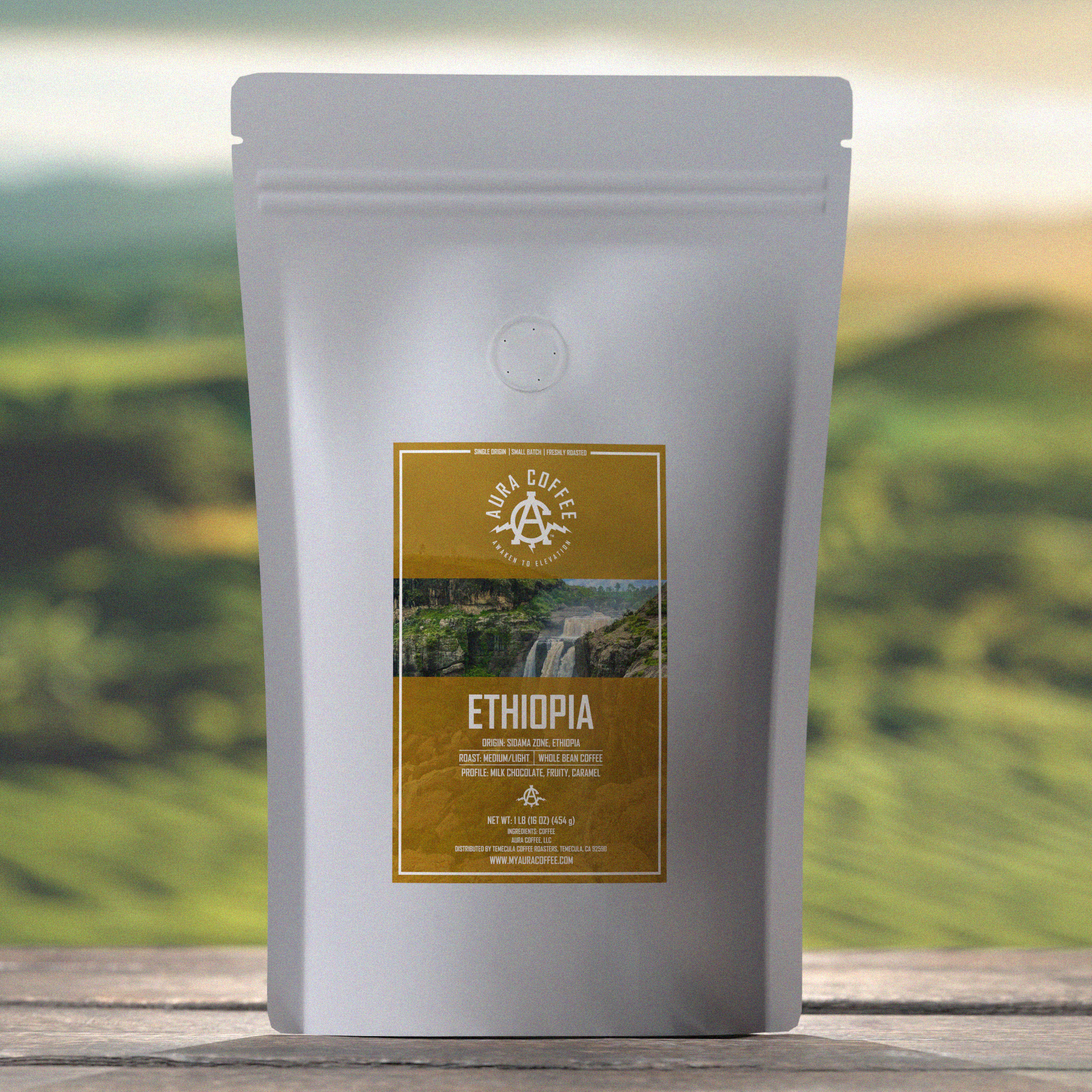 Aura Coffee Ethiopia Single Origin Coffee Pouch sitting on wooden table green rolling hills in the background