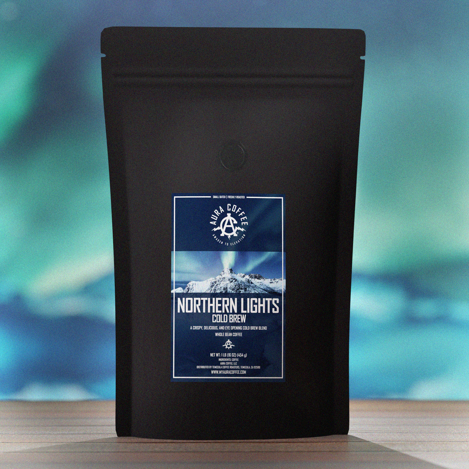 Pouch of Aura Coffee Northern Lights Cold Brew Coffee Blend on a wooden plank the background is northern lights