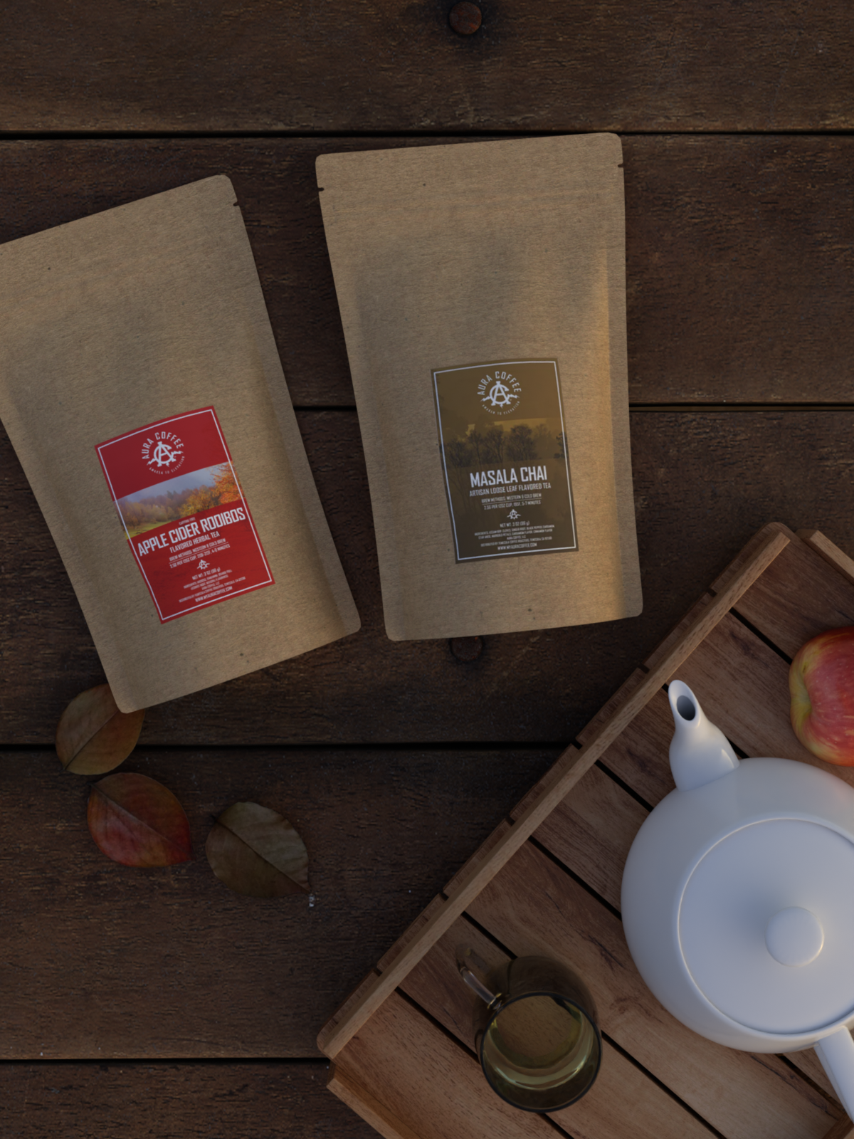 Aura Apple Cider Rooibos, Aura Masala Chai Tea Blends on table next to fall leaves, apples, and a tea kettle.