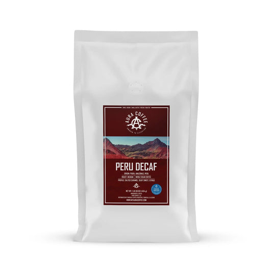 White pouch of Aura Coffee Decaf Peru single-origin coffee.
